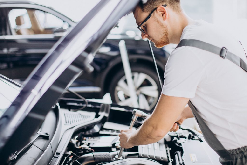 repair man making car service